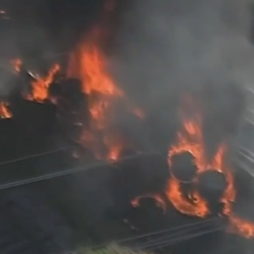 Men filmed pulling driver from flaming semi truck flipped upside down