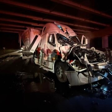 Semi truck smacks into suspended dump bed left behind by dump truck under bridge