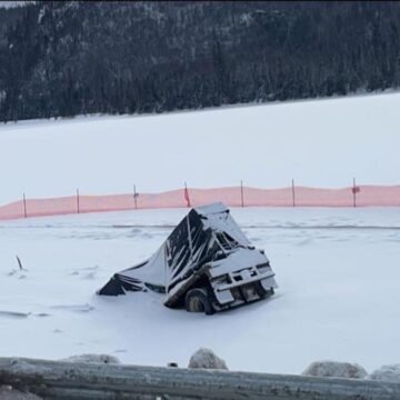 Semi truck that crashed through frozen lake moments after driver escaped cab still sitting there