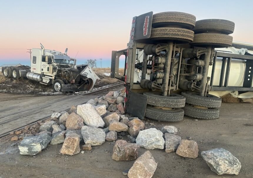 Semi truck and train damaged in collision involving trailer full of rocks