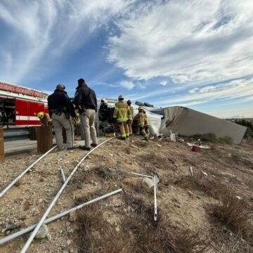 Powerful winds blow over at least a dozen semi trucks in California, one truck driver killed