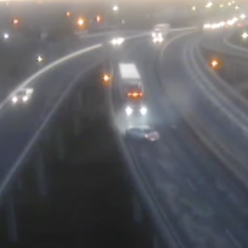 Watch this four-wheer pinball across a narrow highway after cutting off a trucker