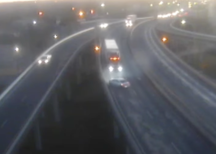 Watch this four-wheer pinball across a narrow highway after cutting off a trucker