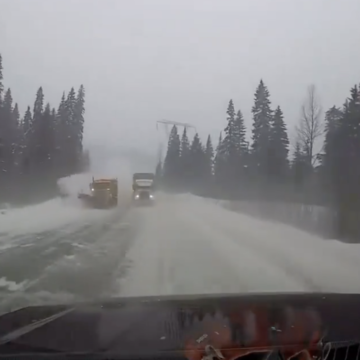 Trucker passing snow plow on a curve almost obliterates motorist